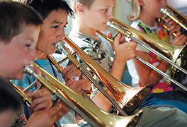 Kinder spielen die Trompete